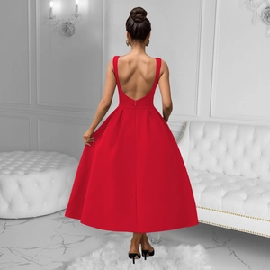 Detail of red backless maxi dress showing U-shaped back cut and elegant pleated skirt