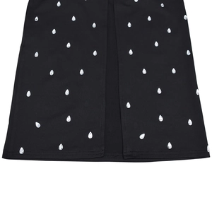 Detail of black dress hem with water-drop rhinestones and central slit design