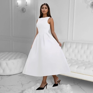 Detail of elegant pleated waist and A-line skirt on white sleeveless maxi dress