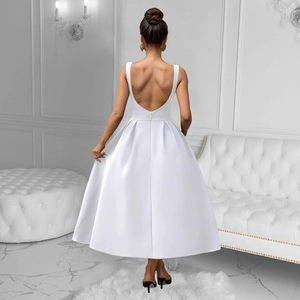 Detail of white satin A-line midi dress featuring a deep V-shaped open back and hidden zipper