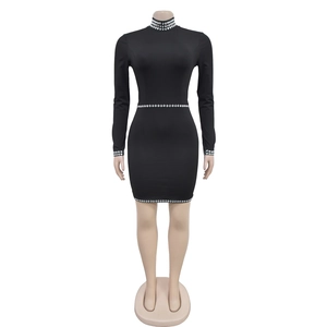 Detailed view of shimmering silver rhinestones on black long sleeve bodycon mini dress