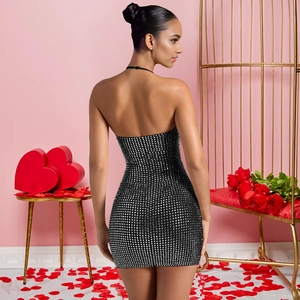 Detail of a black bodycon mini dress with silver rhinestones and halter neck design