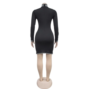 Close-up back view of black bodycon mini dress with silver rhinestones on the collar and hem