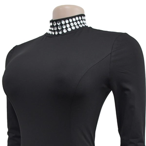 Detailed view of rhinestone embellishments on a black slim-fit high-neck long-sleeve dress