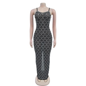 Close-up of sparkling silver rhinestones in a diamond pattern on a black bodycon dress