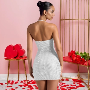 Close-up of sparkling rhinestones on a sexy halter neck bodycon mini dress in silver