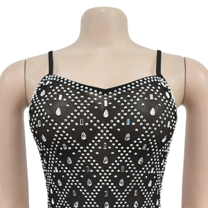 Close-up of black mesh top featuring geometric rhinestone patterns and large drop crystals