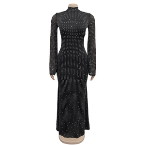 Close-up of black bodycon dress featuring silver rhinestone patterns and mesh sleeves
