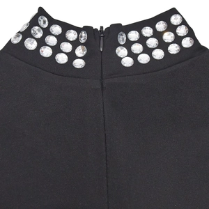 Detail of black turtleneck dress with crystal rhinestones and invisible back zipper