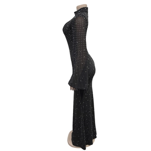 Close-up of black mesh dress featuring sparkling rhinestones and elegant flared sleeves