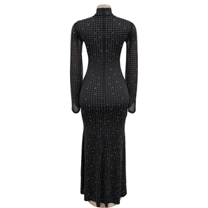 Detailed back view of a slim black dress featuring silver rhinestones and a hidden zipper