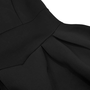 Detailed view of waist pleats and stitching on a black backless French vintage maxi dress