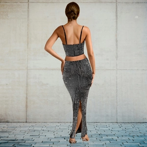 Detail of black two-piece rhinestone set with crop top and slit maxi skirt back view