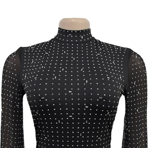 Close-up of black mesh dress with shimmering rhinestones and mock neck detail