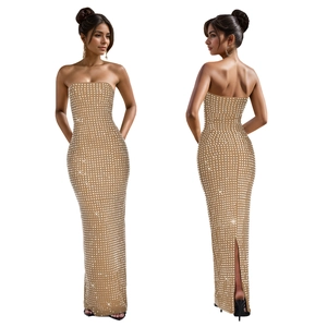 Détail de la robe moulante dorée avec strass brillants et fente à l'arrière de l'ourlet