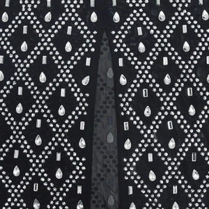 Detail of black mesh dress featuring shimmering rhinestones in a geometric diamond pattern