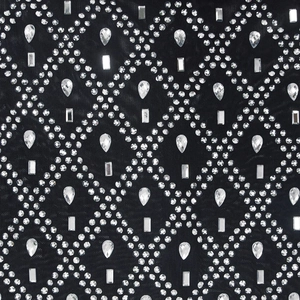 Close-up of black mesh fabric with rhinestones in diamond pattern and crystal details