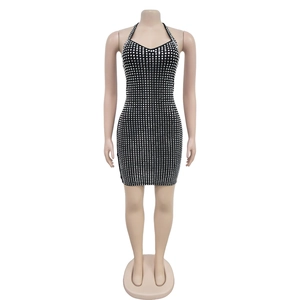 Close-up of black halter dress featuring a geometric silver rhinestone checkered pattern