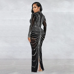 Detail of the elegant back slit and sparkling silver rhinestone pattern on a black maxi dress