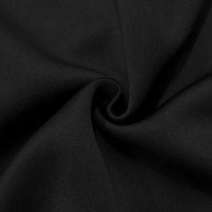 Macro detail of black high-density fabric texture with soft drapes and fine knit pattern