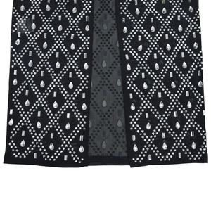 Detail of black mesh dress with silver rhinestones and diamond patterns on hem