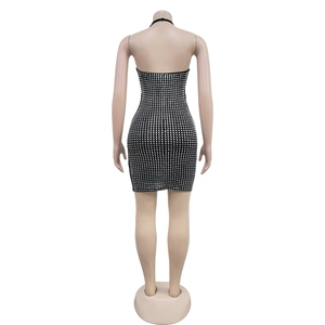 Detail view of the backless halter dress showing sparkling rhinestone grid on fabric