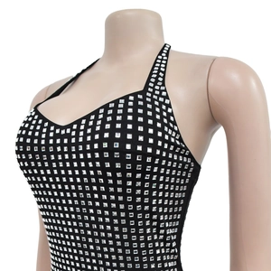 Detail of black halter bodycon dress featuring square silver rhinestones and high-stretch fabric