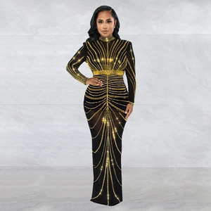 Detail of elegant black long sleeve dress with intricate gold sequins and beads patterns