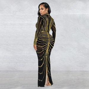 Close-up of black bodycon dress with golden rhinestone sunburst pattern and high neckline