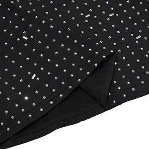 Detail of silver rhinestones on black fabric with reinforced double-stitch edge