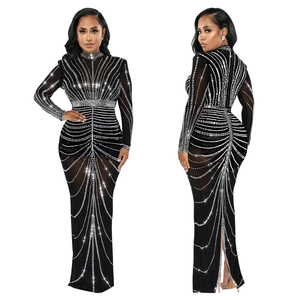 Detail view of black evening gown with silver rhinestones, long sleeves and back slit