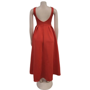 Detail view of red backless sleeveless maxi dress with a deep V-cut and pleated skirt