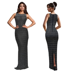 Detail of elegant black bodycon dress with rhinestone patterns and back split design