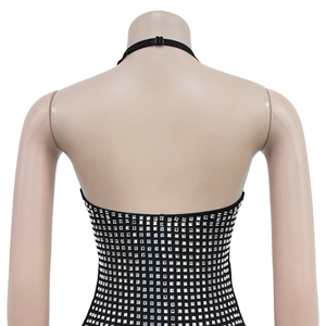 Detail of black halter dress featuring rows of shimmering square silver rhinestones