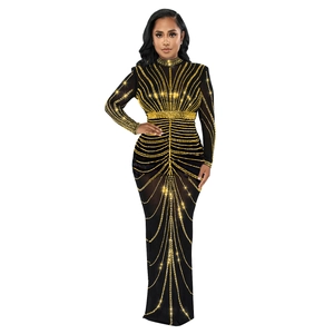 Detail of elegant black sheer evening dress with golden sequin patterns and high neck