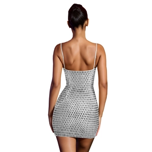 Close-up back view of white mini dress with black rhinestone pattern and open back design