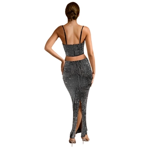 Back view of two-piece plaid set with crop camisole and high-waist split maxi skirt