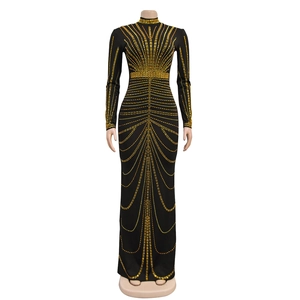 Detail of a black long-sleeve dress featuring intricate gold rhinestone curve patterns