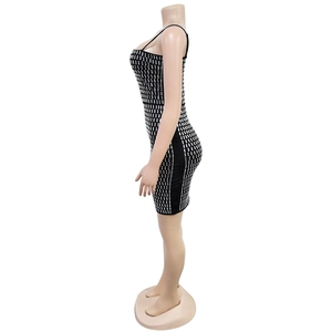 Detailed view of shimmering silver rhinestones on a slim fit black bodycon dress