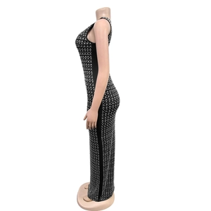 Detail of elegant black bodycon dress with silver rhinestones and a back split hem