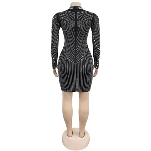 Detail of invisible back zipper on black slim fit dress with rhinestone and pearl patterns