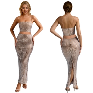 Detail of sequin mesh crop top and high waist slit skirt with back zipper closure