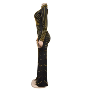 Detail of the high neck long sleeve black maxi dress with golden rhinestone patterns