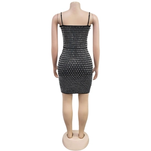Detailed back view of a slim-fit black mini dress with shiny silver rectangular rhinestones