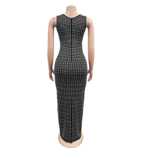 Detail of a slim fit black evening dress with silver rhinestone embellishments and back zipper