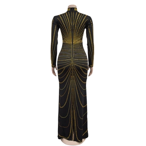 Back view of elegant black long sleeve gown with gold rhinestones and slit