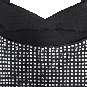 Detail of V-neckline on black dress featuring precision square silver rhinestones