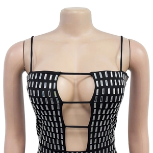 Detail of black mini dress featuring chest cut-outs and rectangular rhinestone patterns