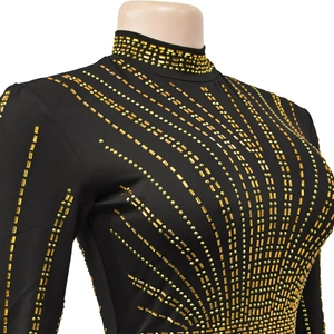 Close-up of golden rhinestone geometric pattern on black long sleeve bodycon dress
