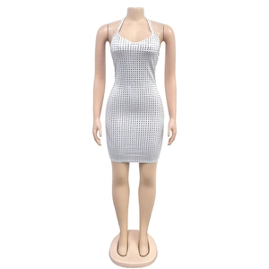 Detailed view of white halter mini dress with square silver sequins on mannequin